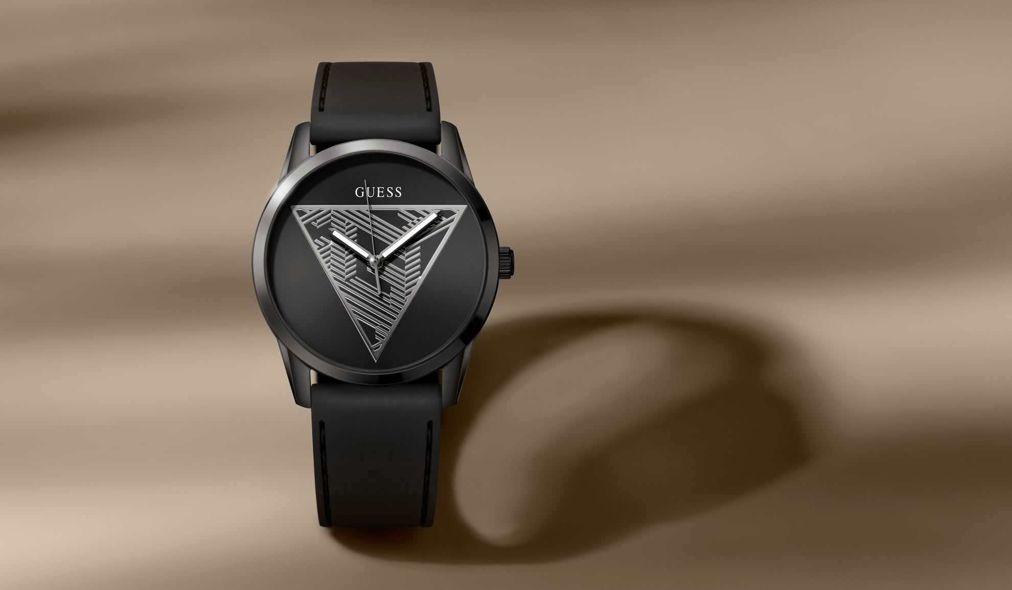 Black Guess watch on a brown background GW0957G3