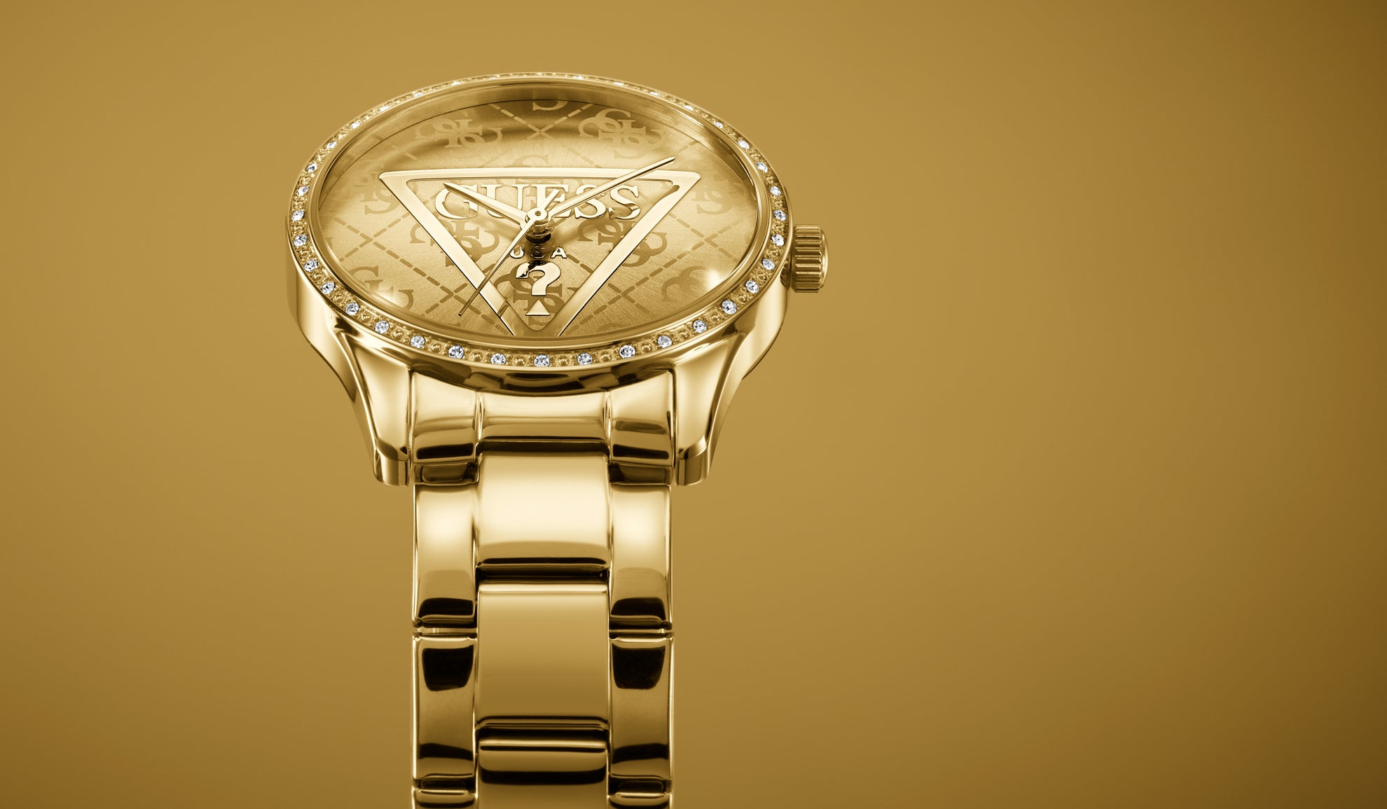 Gold GUESS Watch with logo dial at a tilted angle