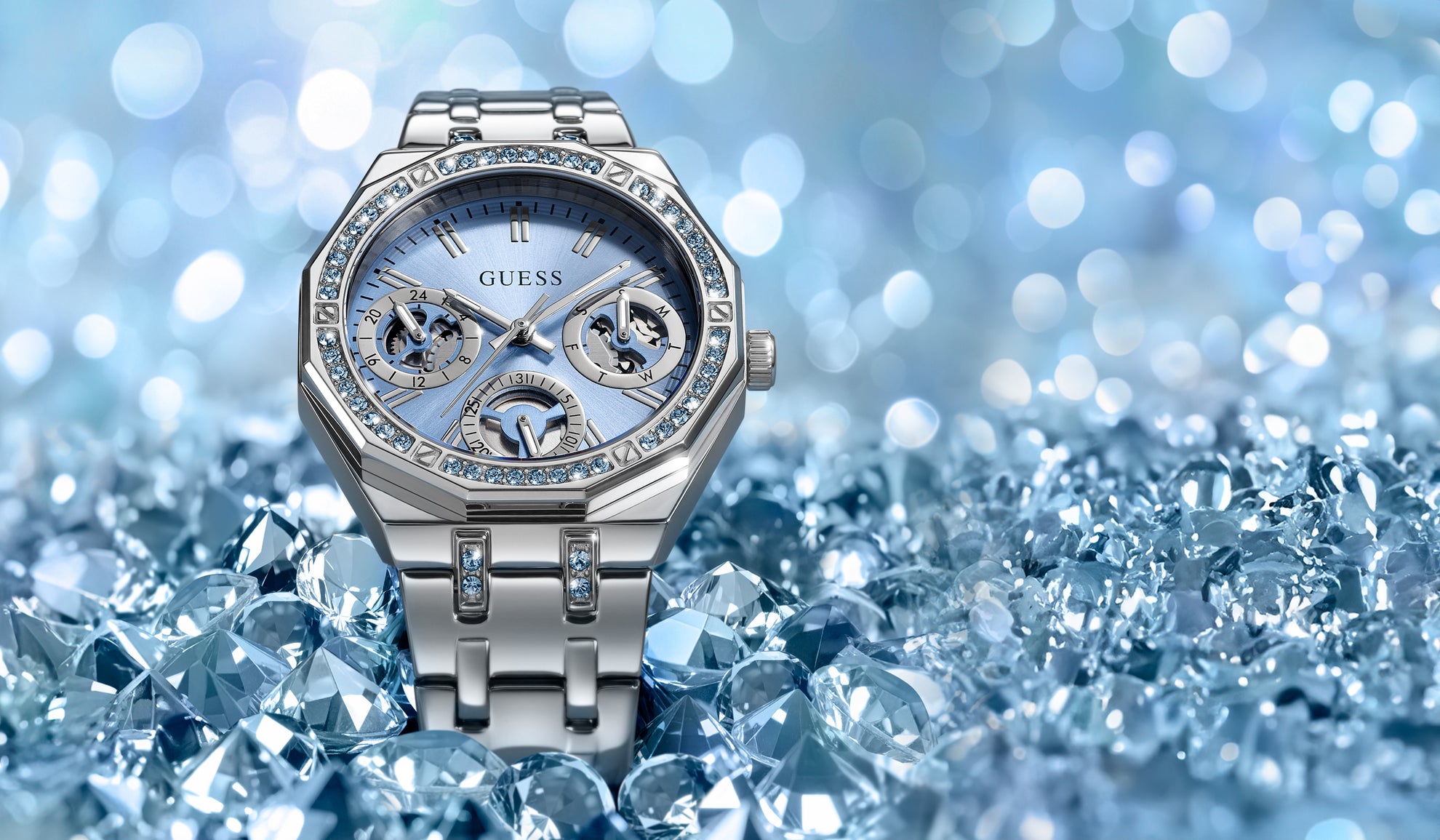 Silver watch with gemstones on a blue diamond-studded background GW1009L1