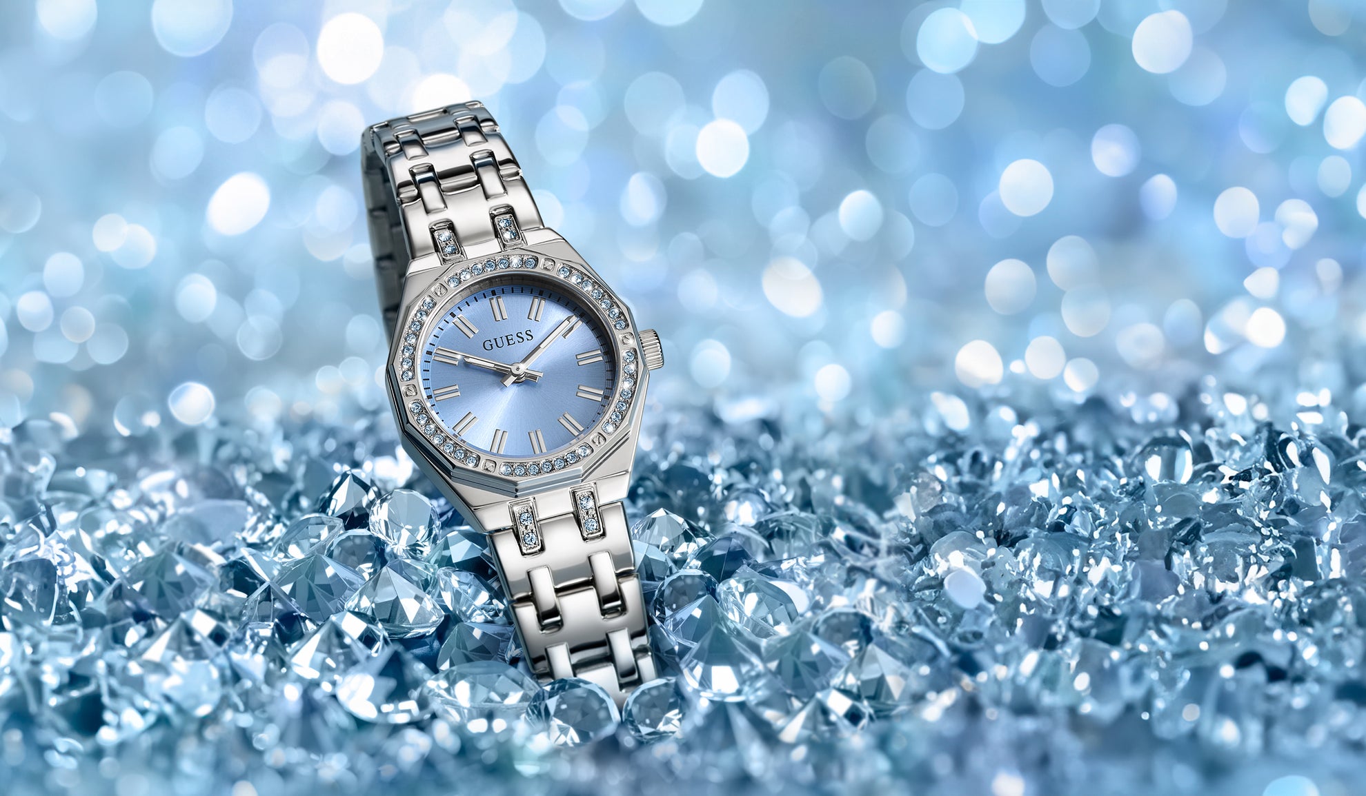Silver watch with blue face on a blue crystal-like surface