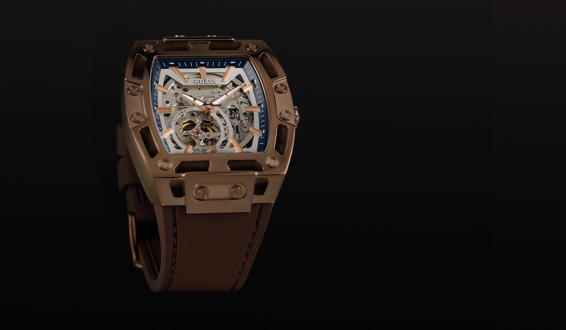 Brown watch with a detailed face on a black background