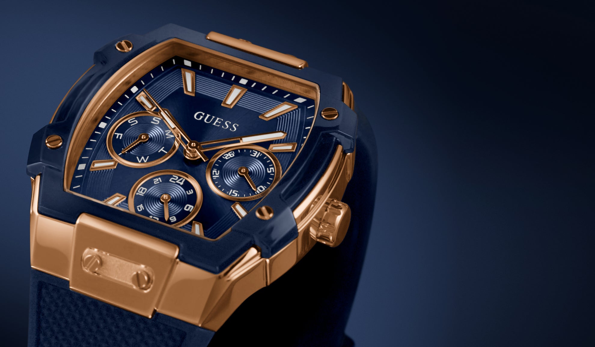 Blue and gold Guess watch on a dark background GW0956G4
