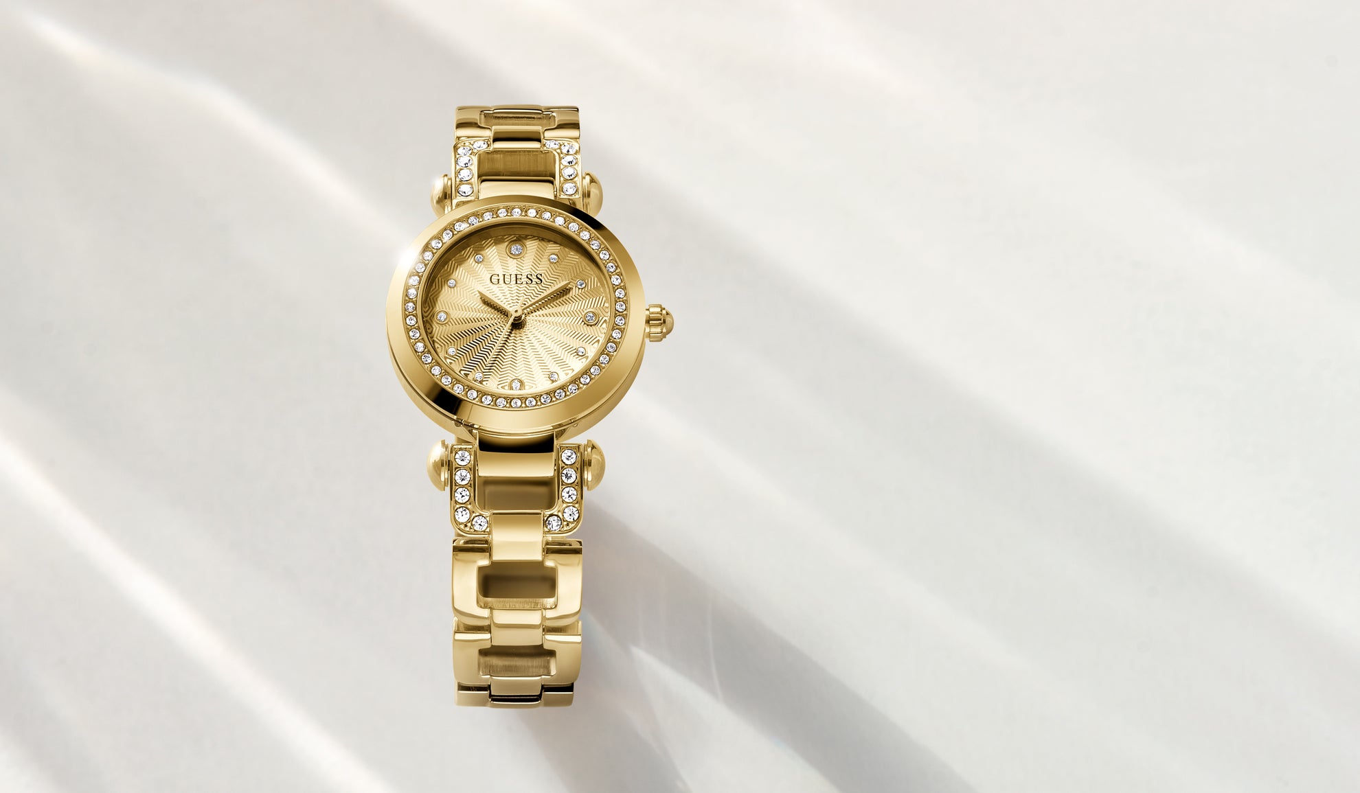 Gold watch with a diamond-studded bezel on a white background gw0869l4