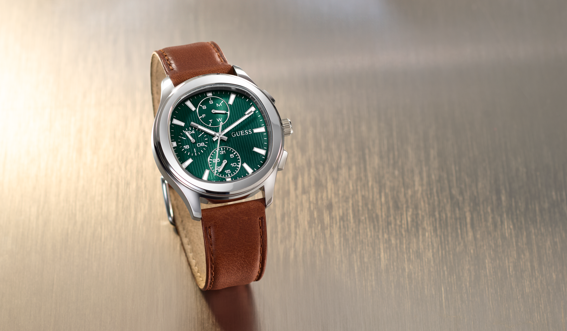 Wristwatch GW1049G1 with brown leather strap and green dial on a metallic background