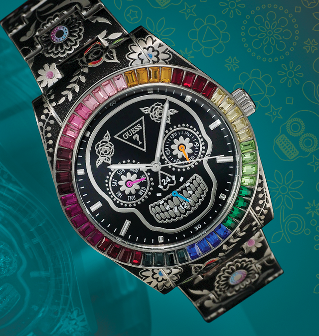 GW0962G1 watch with colorful gemstones on a teal background