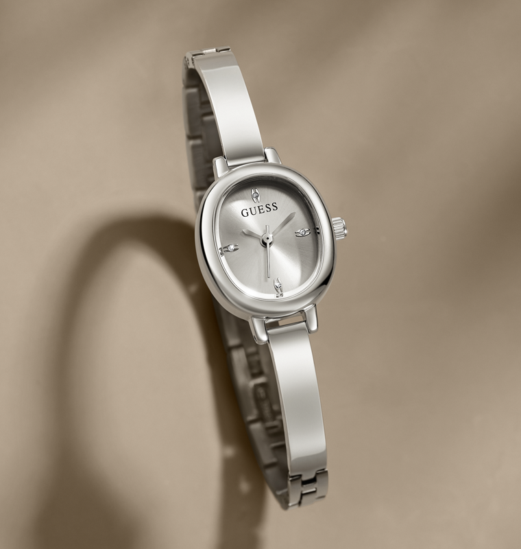 Silver Guess watch on a beige background
