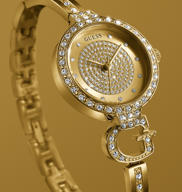 Gold Guess watch with diamond accents on a gold background GW0929L2