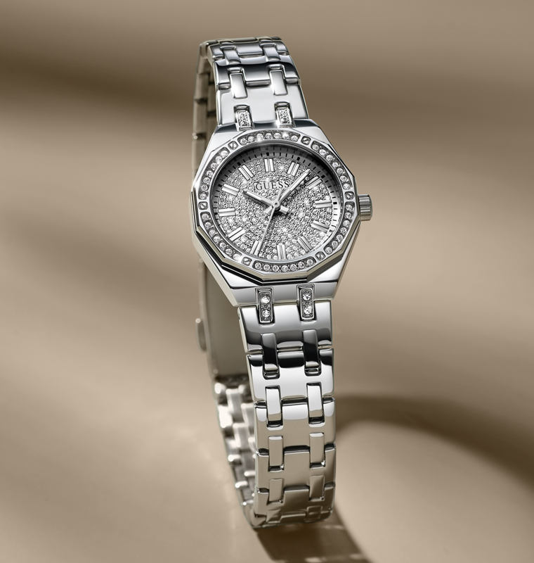 Silver watch with diamond-studded face on a beige background