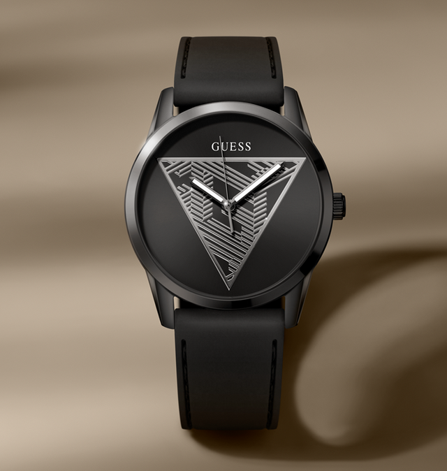Black Guess watch with triangle design on a beige background