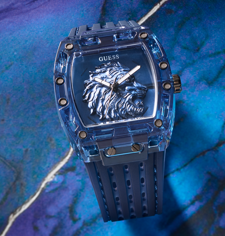Blue Guess watch with lion emblem on a blue textured background