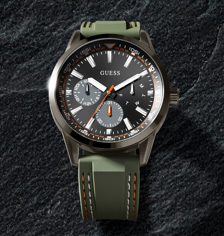 mens sport watch with orange pop stitching on a stone background