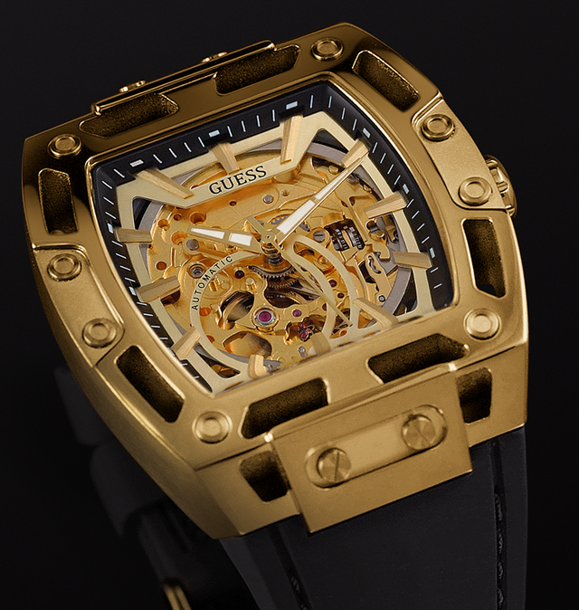 Gold skeleton watch with black strap on a dark background