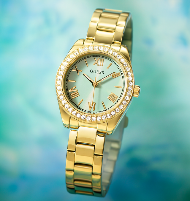 womens gold watch with crystals on bezel and aqua green dial on aqua background