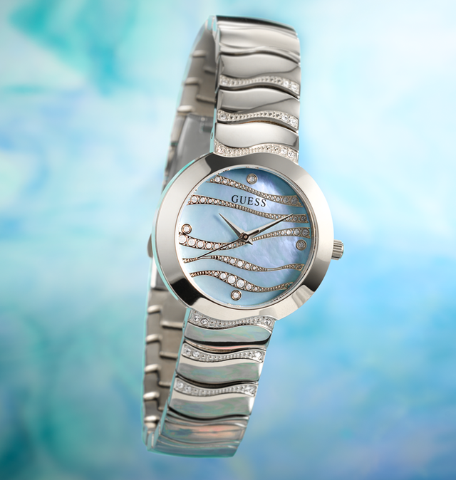 womens silver watch with wave pattern on dial in mother of pearl blue on a greenish blue background