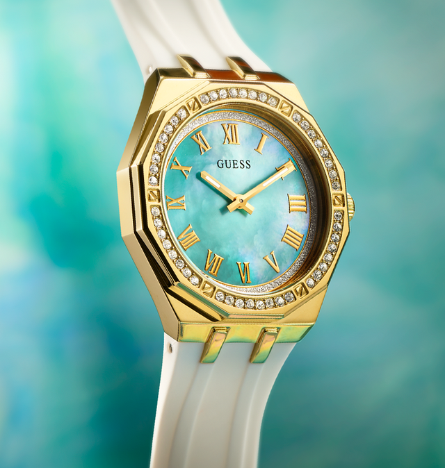 womens watch with white silicone strap , octogon shapped gold case and mother of pearl dial on ethereal background