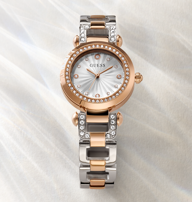 Two-tone Guess watch with rose gold and silver band on a white background