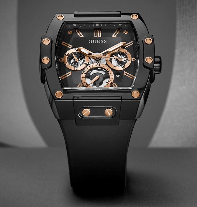 Black and rose gold Guess watch on a gray background gw0203g8