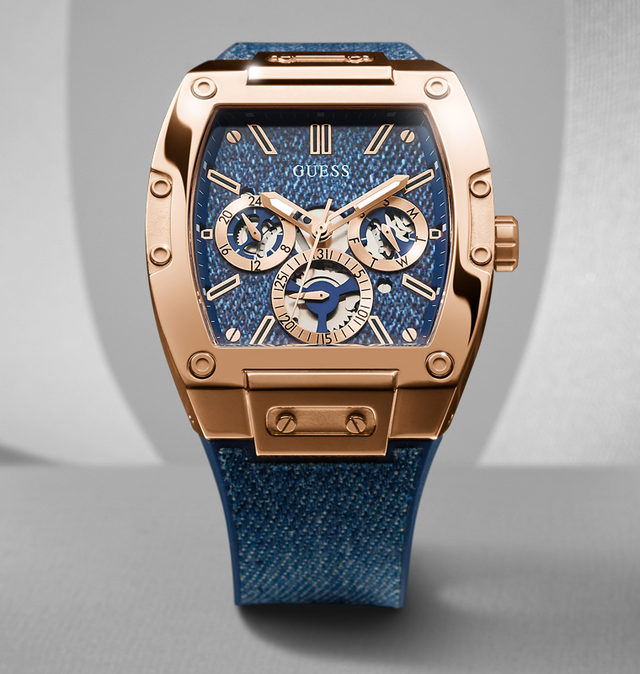 Guess watch with blue face and rose gold case on gray background gw0786g2