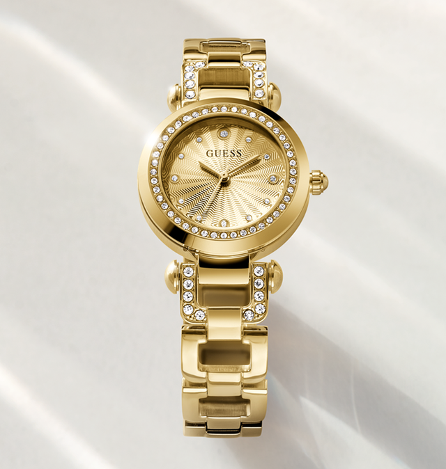 Gold watch with gemstone accents on a white background 