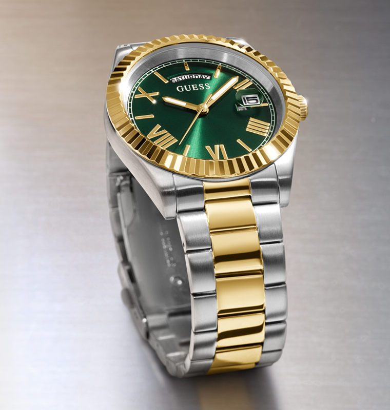 Two-tone silver and gold watch with a green dial on a gray background