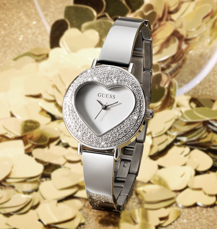 Womens silver watch with heart shaped case on a gold background