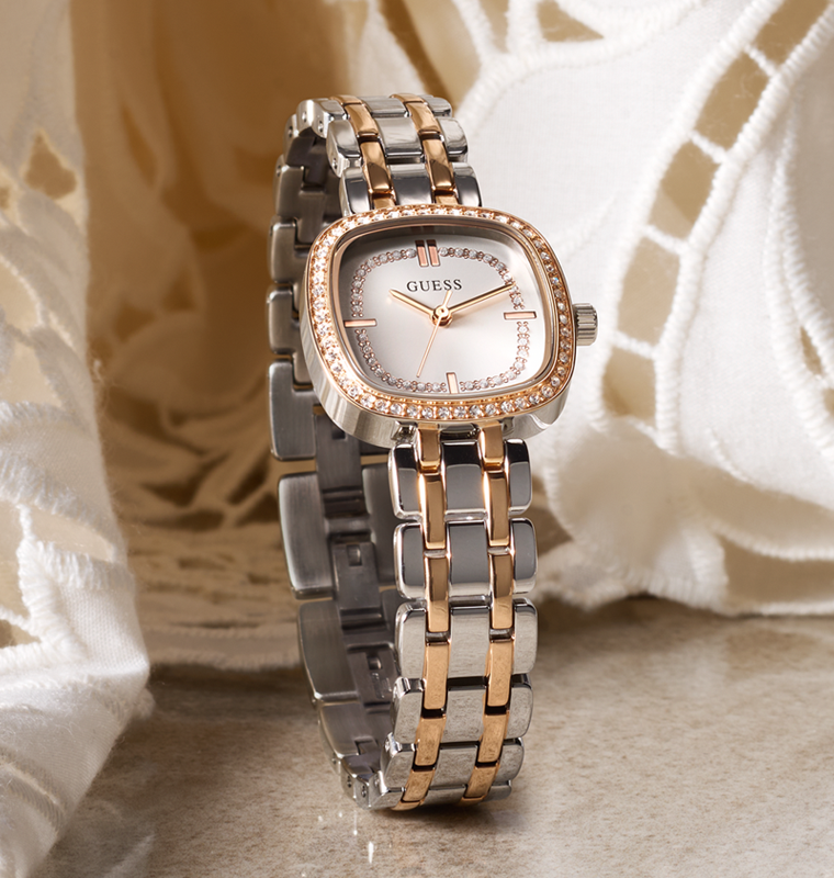 Silver and rose gold watch with a white floral background