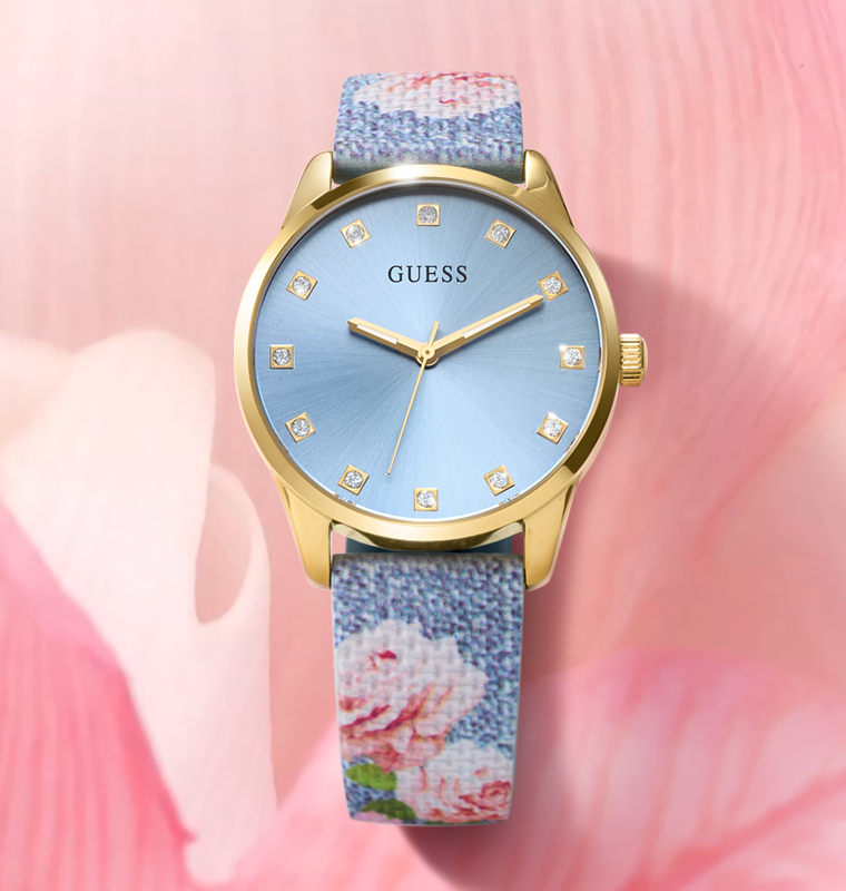 Guess watch with floral strap on a pink background
