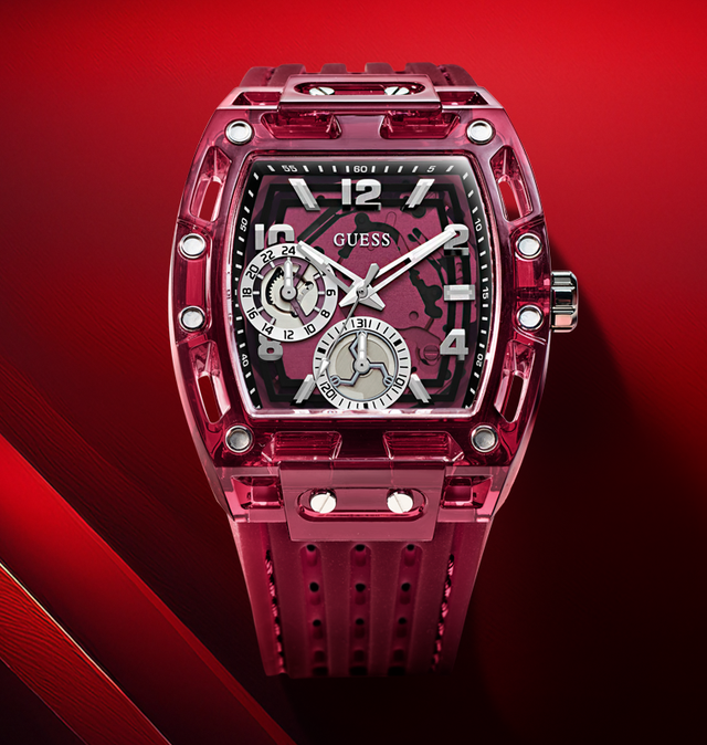 Red Guess watch with transparent face on a red background gw0499g12