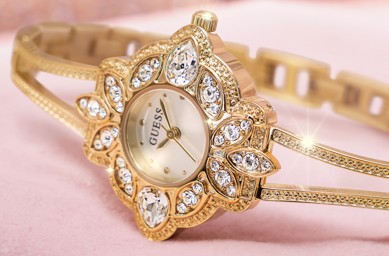 gold and rose gold womens watches with floral shaped case on pink background