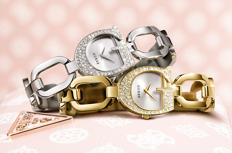 gold and silver watches on logo patterned background
