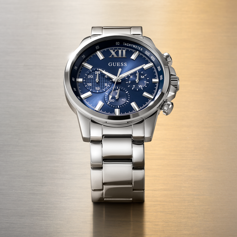 Silver Guess watch with a blue dial on a gradient background