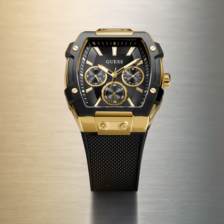 Gold and black watch with 'GUESS' branding on a gradient background