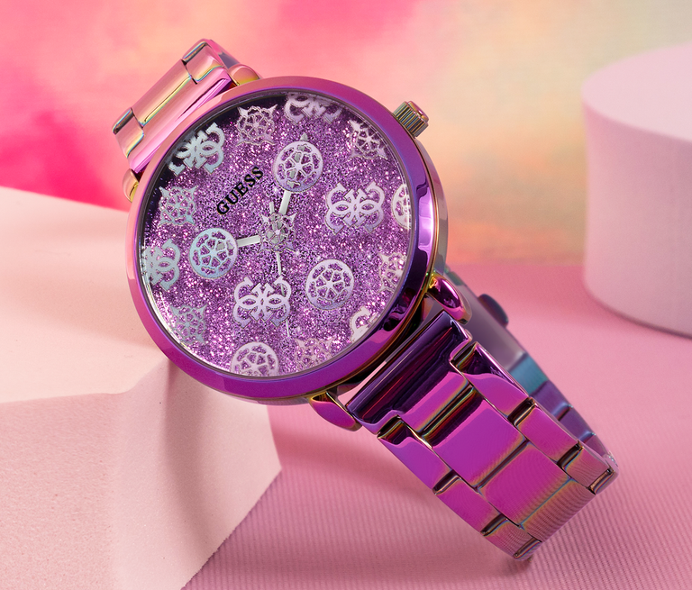 iridescent watch with logo pattern dial on pink background