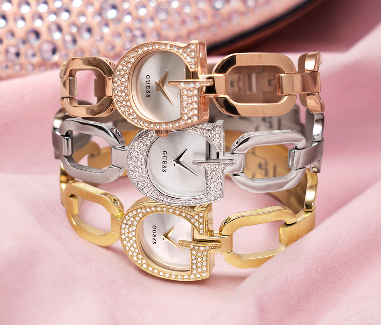silver, gold and rose gold watches in a stack with G shaped case