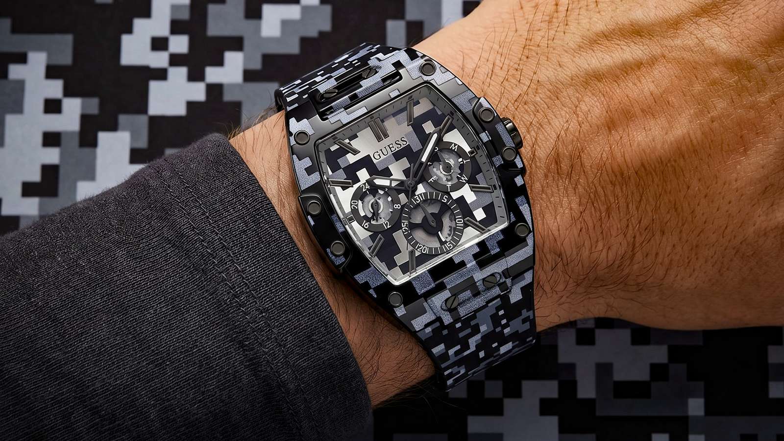 A seamless AI-generated print flows across the 42mm black case, multifunction dial, and smooth silicone strap, creating a unified, graphic look that feels both futuristic and unmistakably GUESS.