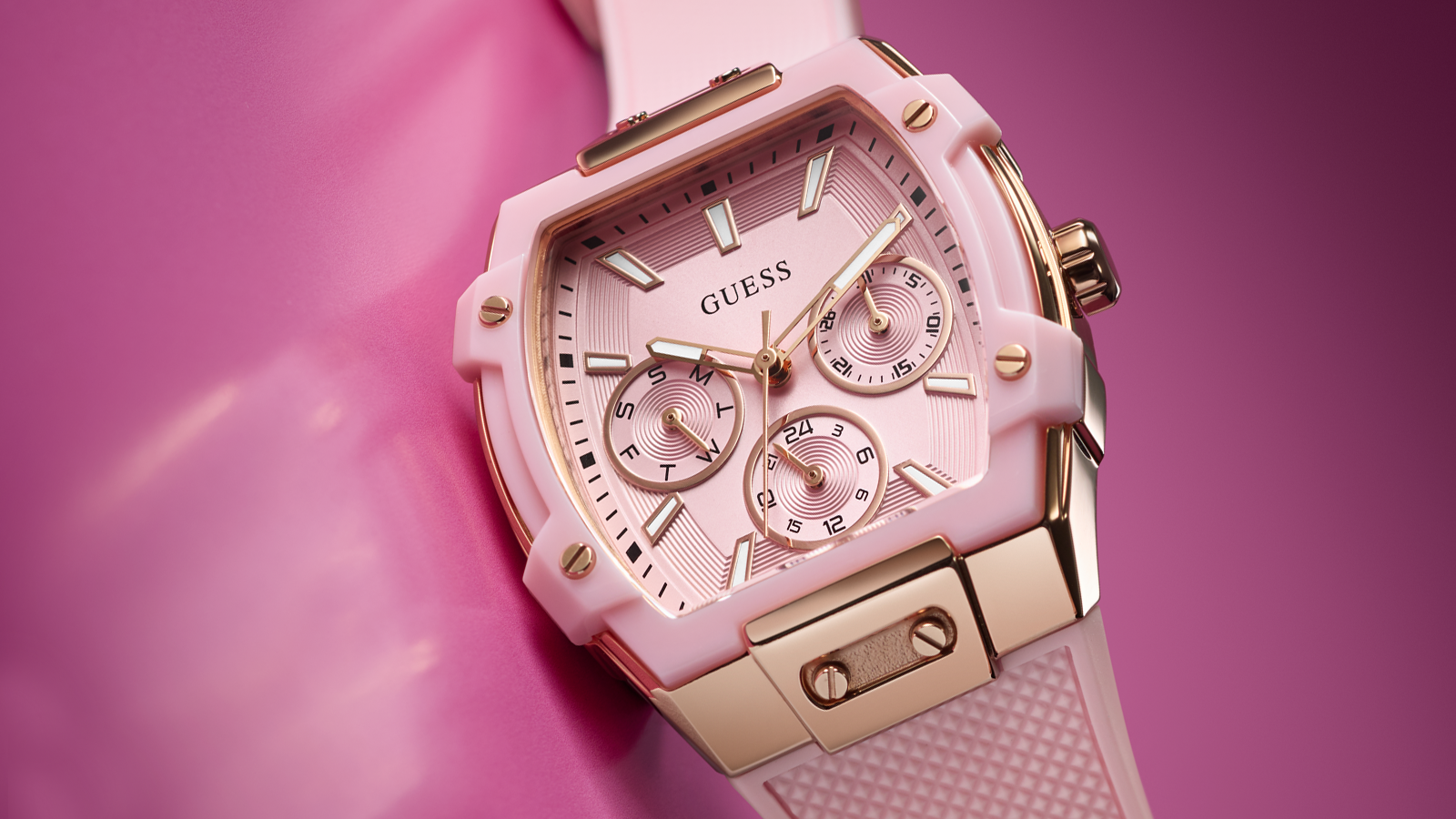 Pink and gold Guess watch on a pink background Pink transparent watch with black strap on a pink background