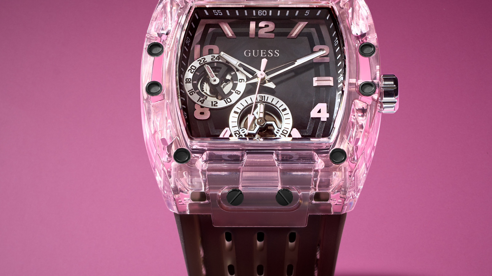 Pink transparent watch with black strap on a pink background