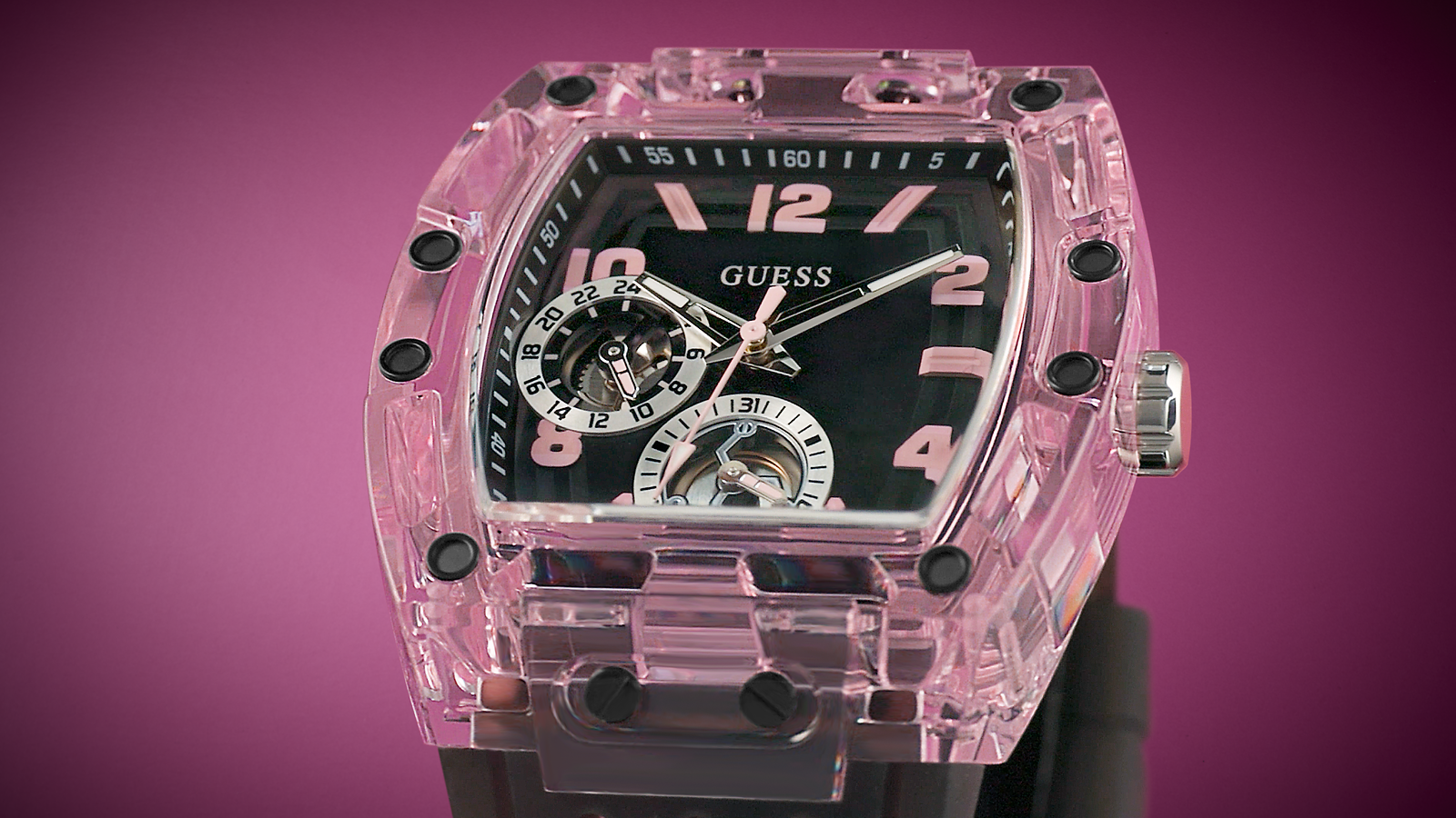Pink transparent Guess watch with black face on a pink background