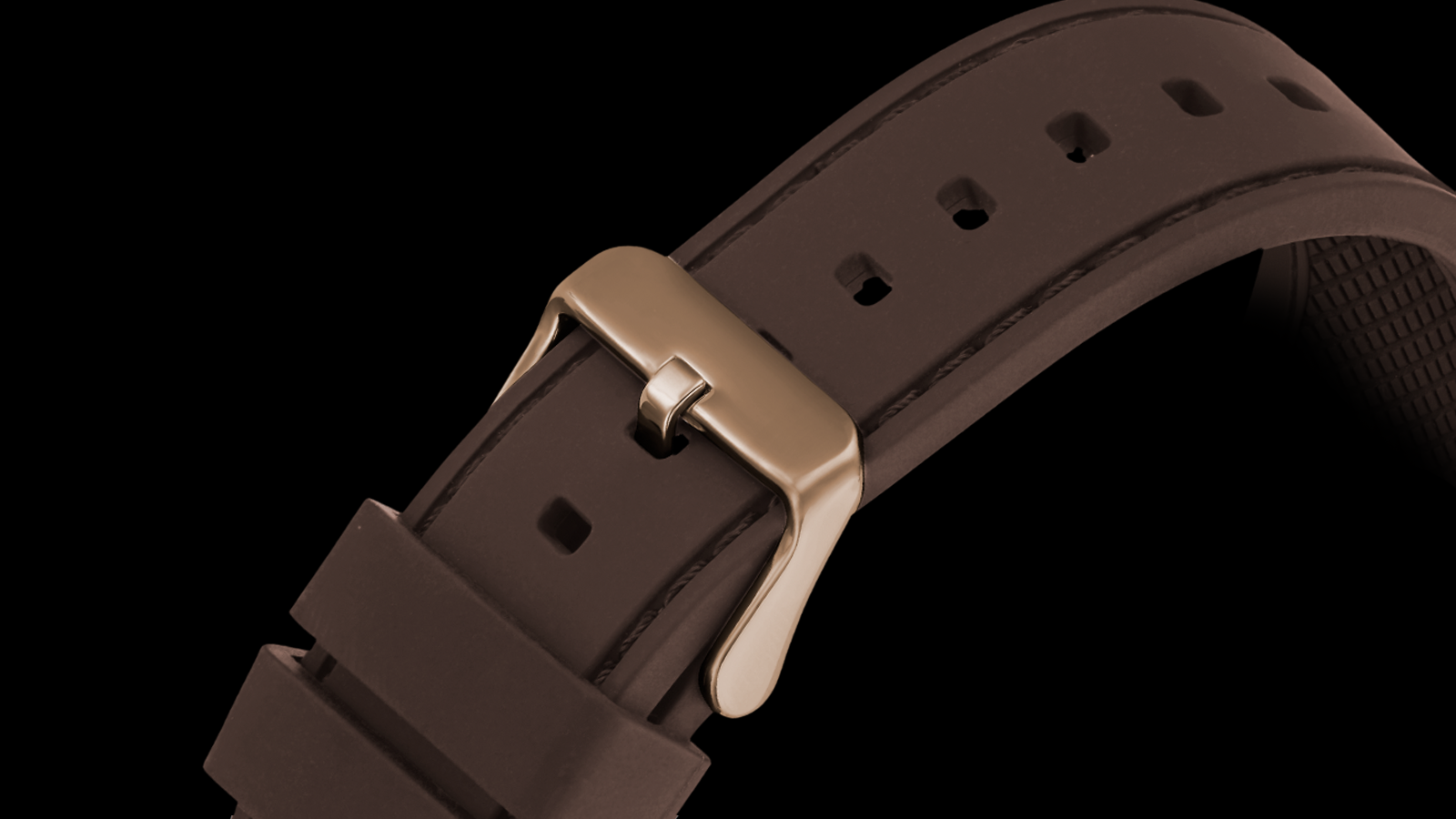 Brown watch strap with gold buckle on a black background