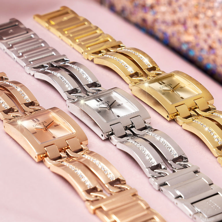 silver, gold and rose gold watches lying on pink background