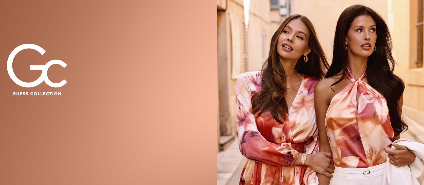 Two women wearing matching floral outfits with Guess Collection logo on a beige background