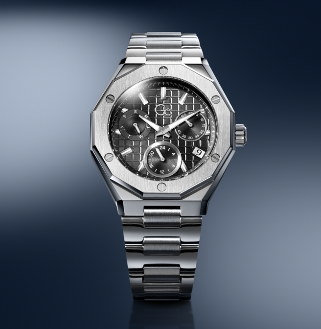 A stainless steel wristwatch with an octagonal bezel, a dark patterned dial, and a matching steel link bracelet, shown against a dark blue gradient background.