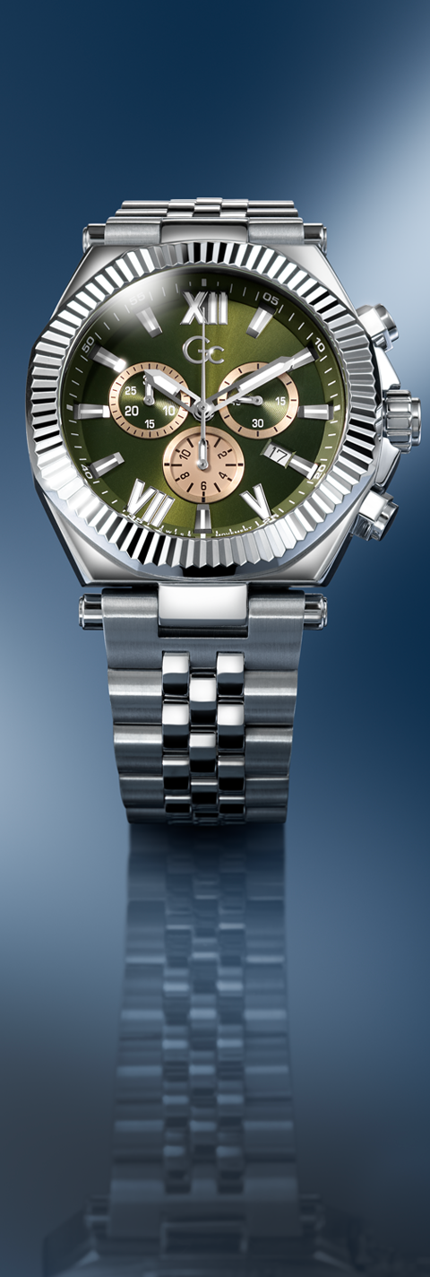 Silver watch with a green face on a reflective blue background
