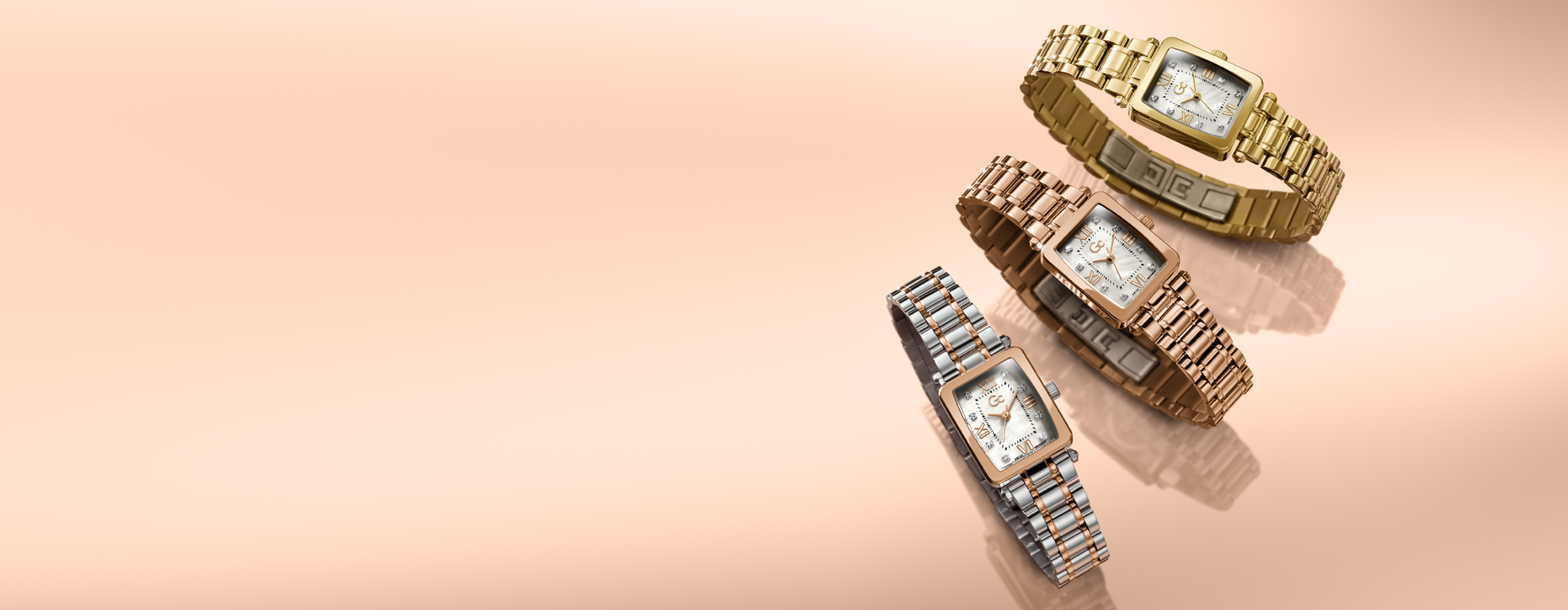 Three gold and rose gold bracelets with diamond accents on a light pink background