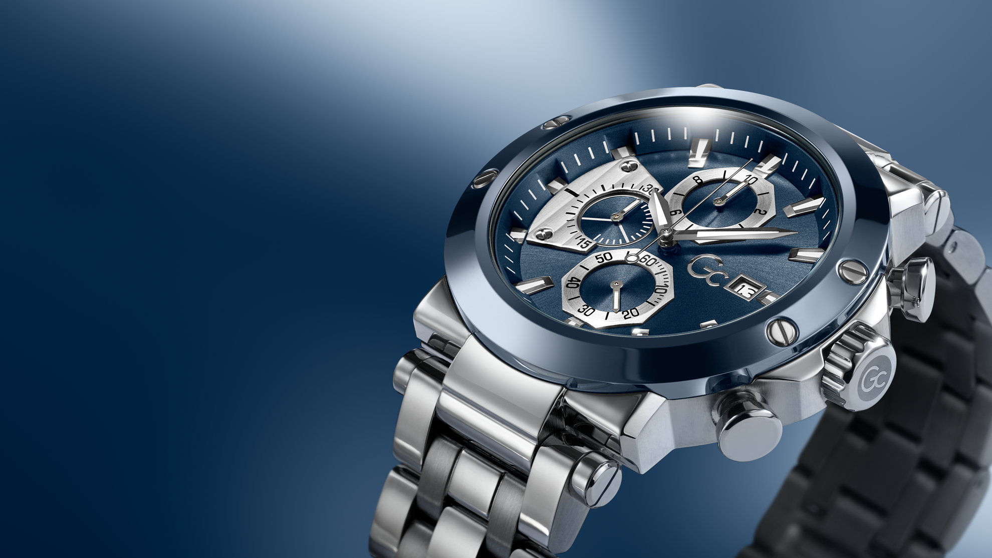 Gc TechnoForce Chrono Metal watch with a blue face and silver case on a gradient blue background