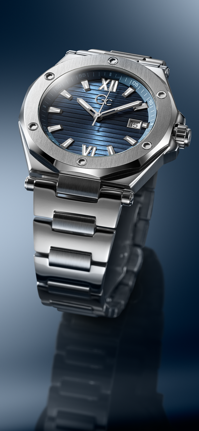 Silver watch with blue face on a reflective surface Z67001G7