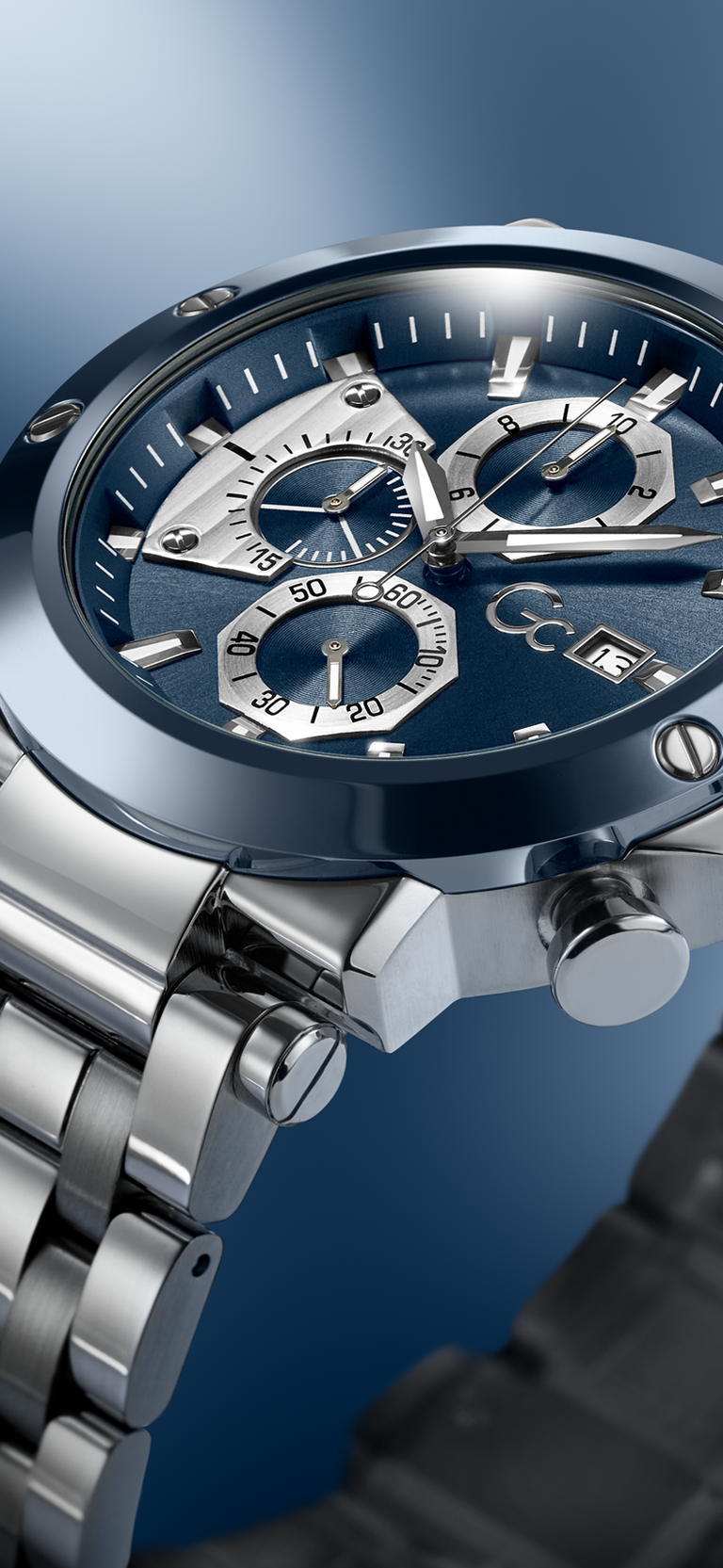 Close-up of a Gc TechnoForce Chrono Metal watch with a blue face on a blue gradient background
