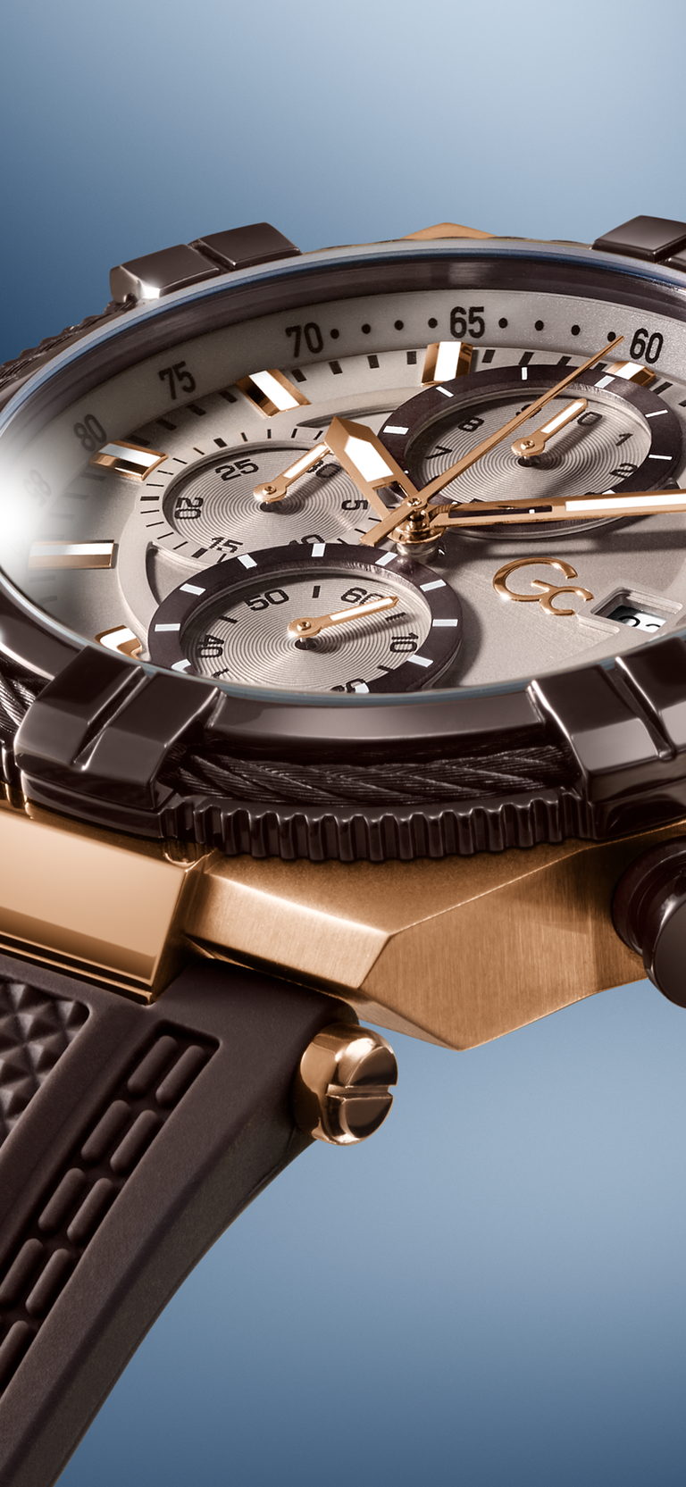 Close-up of a luxurious Gc IronForce Chrono Silicone watch with detailed design on a blue background