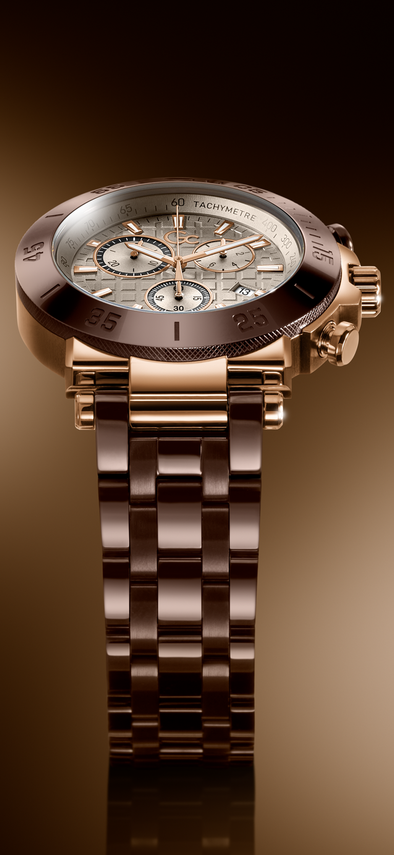 A luxury chronograph watch with a rose gold-tone metal bracelet and case, featuring a white dial with multiple sub-dials and a dark bezel, set against a dark brown gradient background.