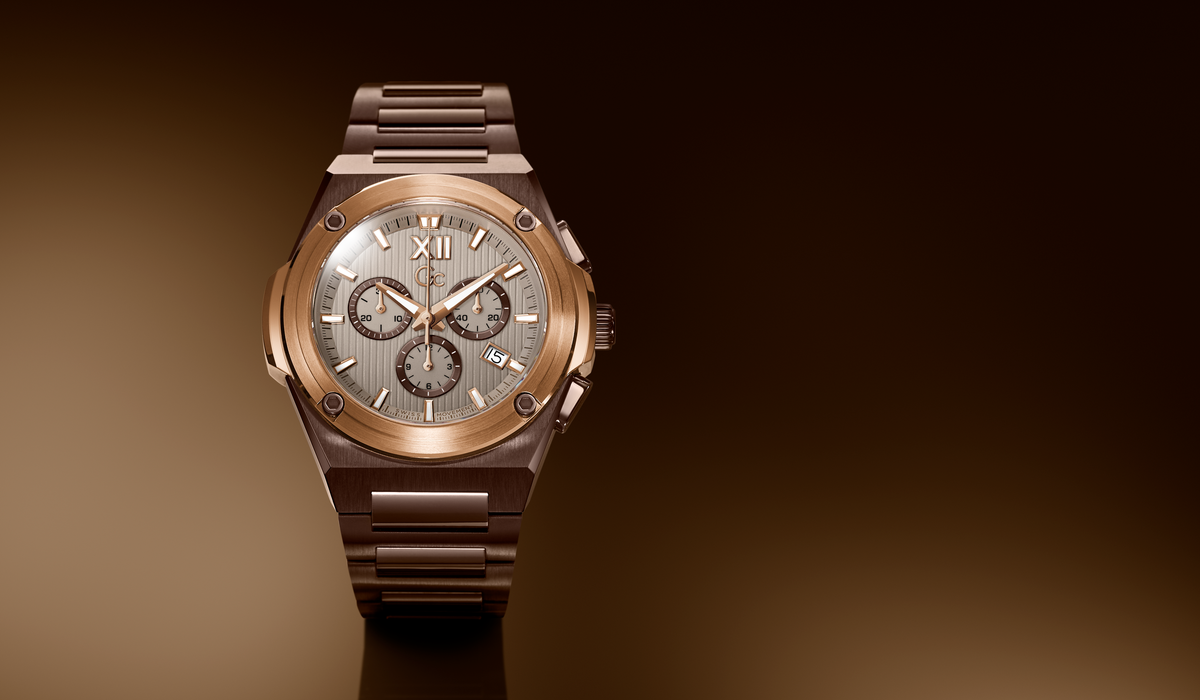 A luxury chronograph watch with a rose gold-toned metal bracelet and case, featuring a silver-toned dial with black subdials and Roman numeral XII.
